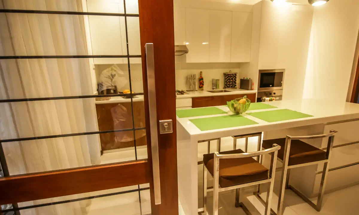 Breakfast table seen through a timber-framed sliding door